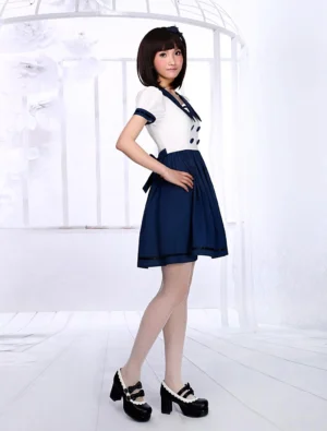 Sailor style lolita dress right side full body profile showing navy trim collar and cuffs, high waistline, flared silhouette, and platform shoes on model in white photo studio