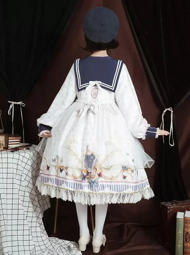 Sailor academic lolita one-piece dress sleeve detail showing ruffled long sleeves, lace cuff trim, and vintage print on polyester fabric