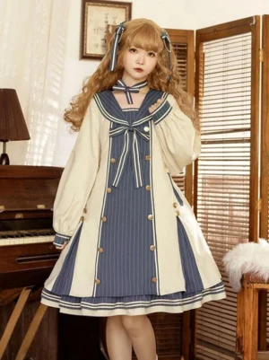 Front full-body view of cream and navy sailor sweet lolita dress with bow embellishments, long puff sleeves, and navy striped panels, worn by model with curly blonde hair and matching hair bows in vintage piano room setting
