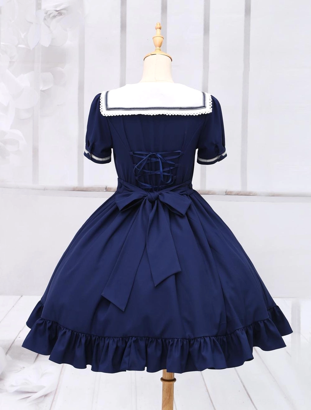 Sailor sweet lolita one-piece dress back view, lace-up back detail and large back bow with ruffled skirt