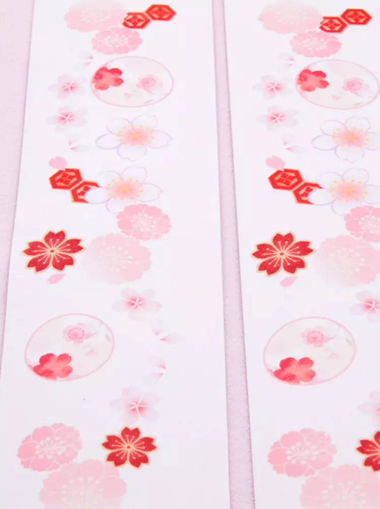Flat lay fabric sample view of sakura thigh-high lolita socks showing pink and red cherry blossom with circular prints on white base