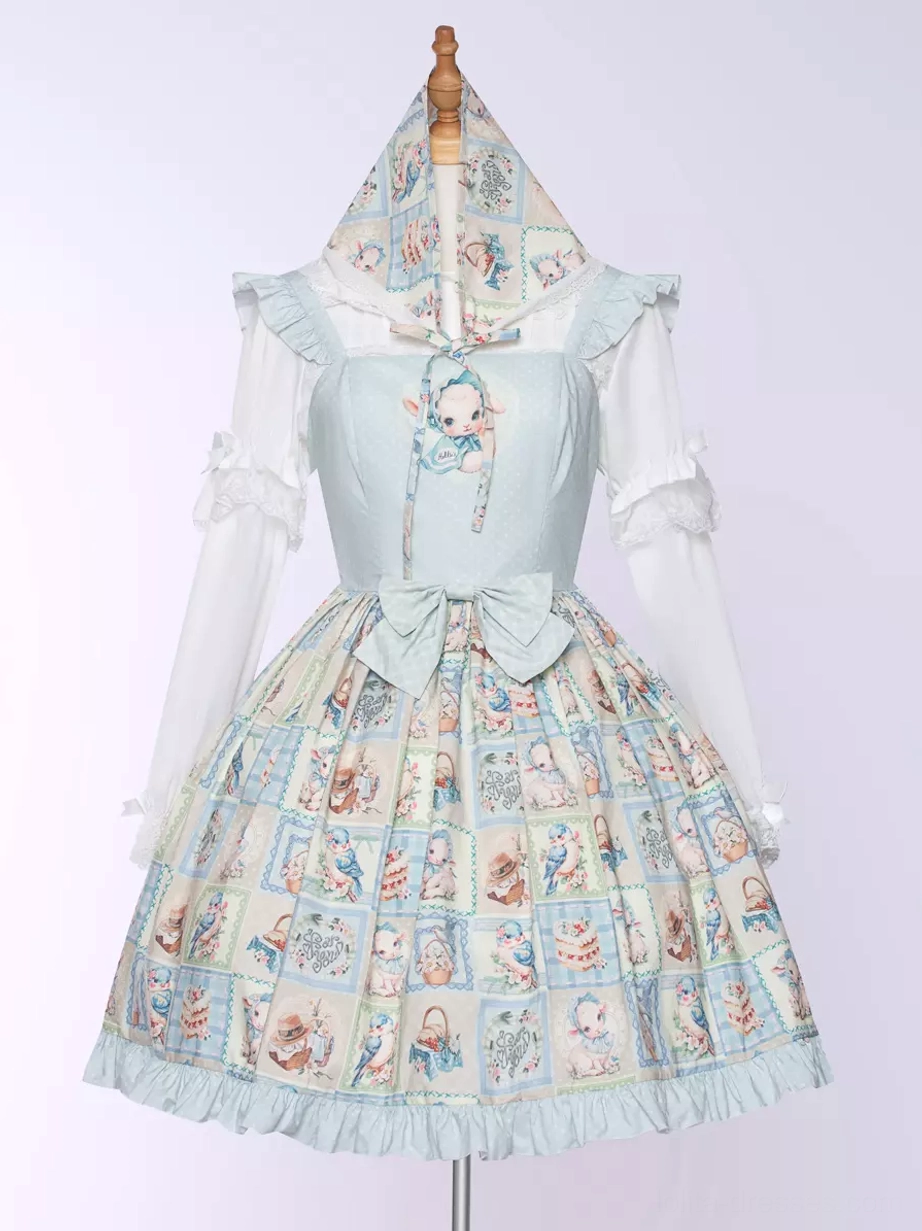 Front three-quarter display shot of sheep bird cake print sweet lolita JSK on dress form showing matching printed headscarf, sheer puff sleeves, ruffled hem, and waist bow