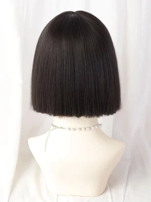 Short black sweet lolita bob wig rear view showing neat straight bob ends and overall silhouette, displayed on mannequin with pearl chain necklace for complete coordinate aesthetic