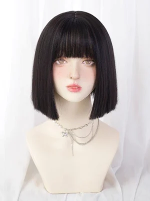 Short bob sweet lolita wig in pure black, front view on mannequin bust displaying layered bangs and smooth heat-resistant synthetic fiber texture, styled with silver chain necklaces for coordinate inspiration