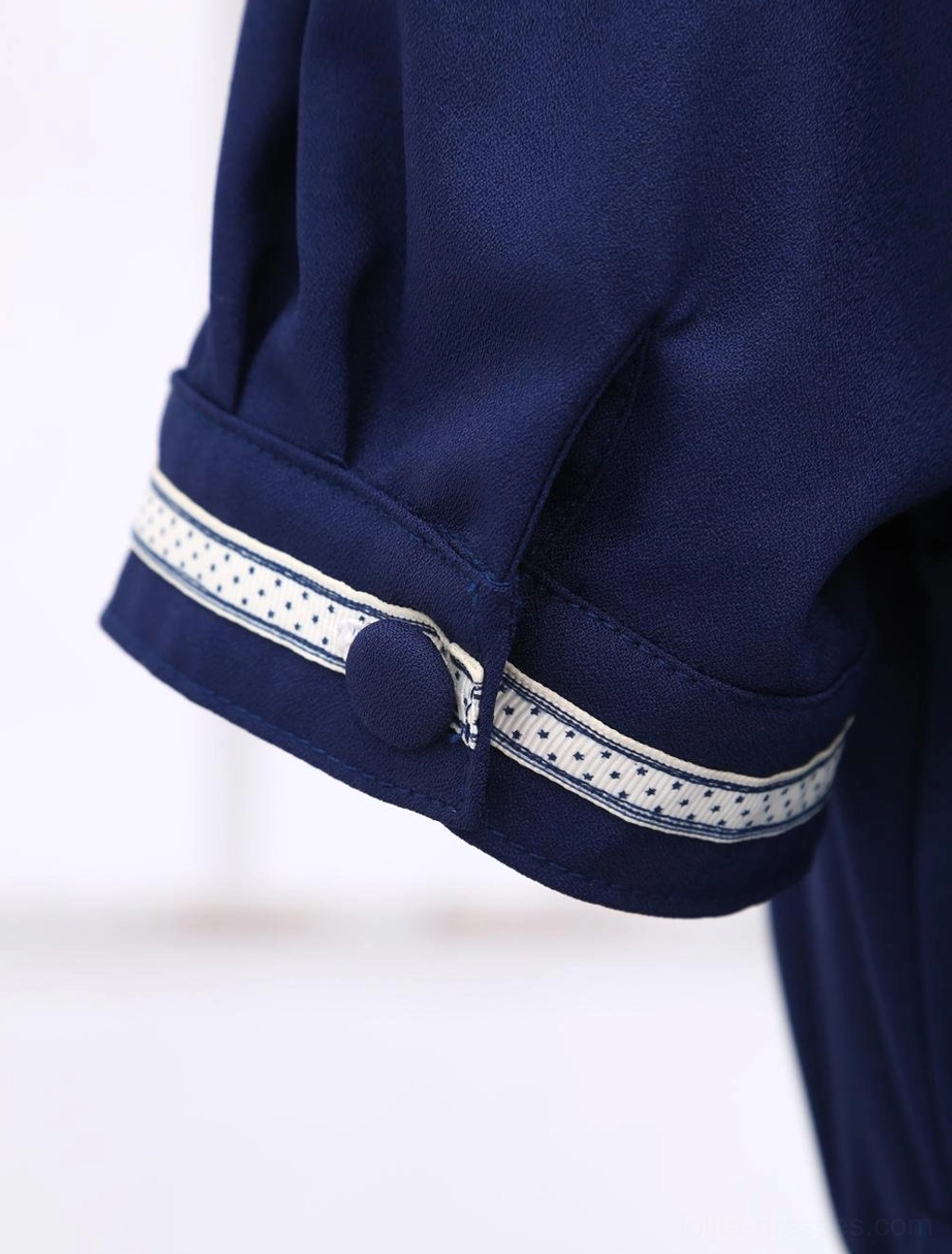 Short sleeve cuff detail, white polka-dot trim and round navy blue button decoration on lolita dress