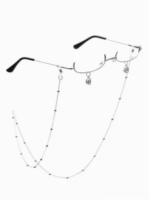 Silver beaded glasses chain with pendant charms and black half-frame lolita eyewear accessory shown in flat lay against white background, front view featuring mixed metal tones and decorative chain embellishments
