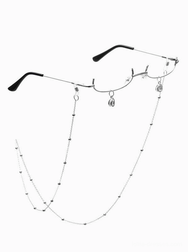 Silver beaded glasses chain with pendant charms and black half-frame lolita eyewear accessory shown in flat lay against white background, front view featuring mixed metal tones and decorative chain embellishments