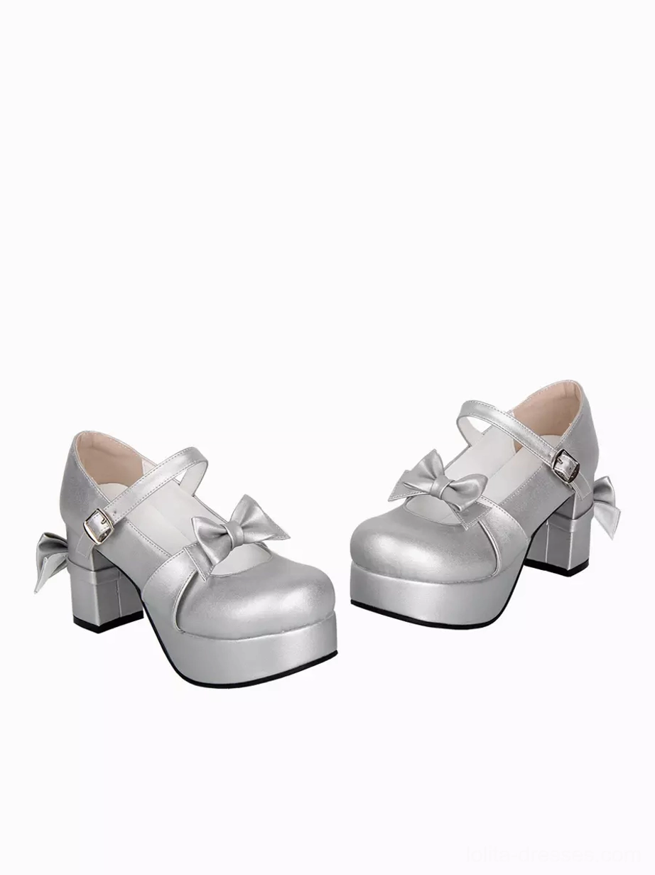 side three quarter perspective of silver lolita platform pumps showing chunky block heel thick platform sole and vamp bow embellishment