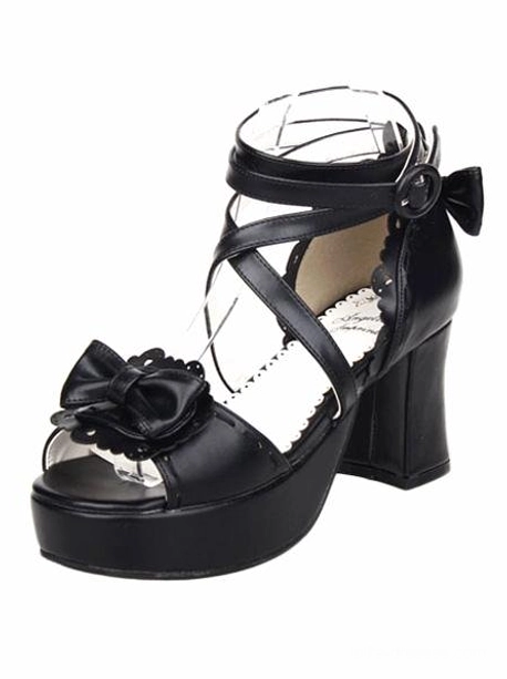 Single black lolita platform sandal front-side view displaying cross ankle straps, side ankle bow accent, and bow decoration on peep toe cap
