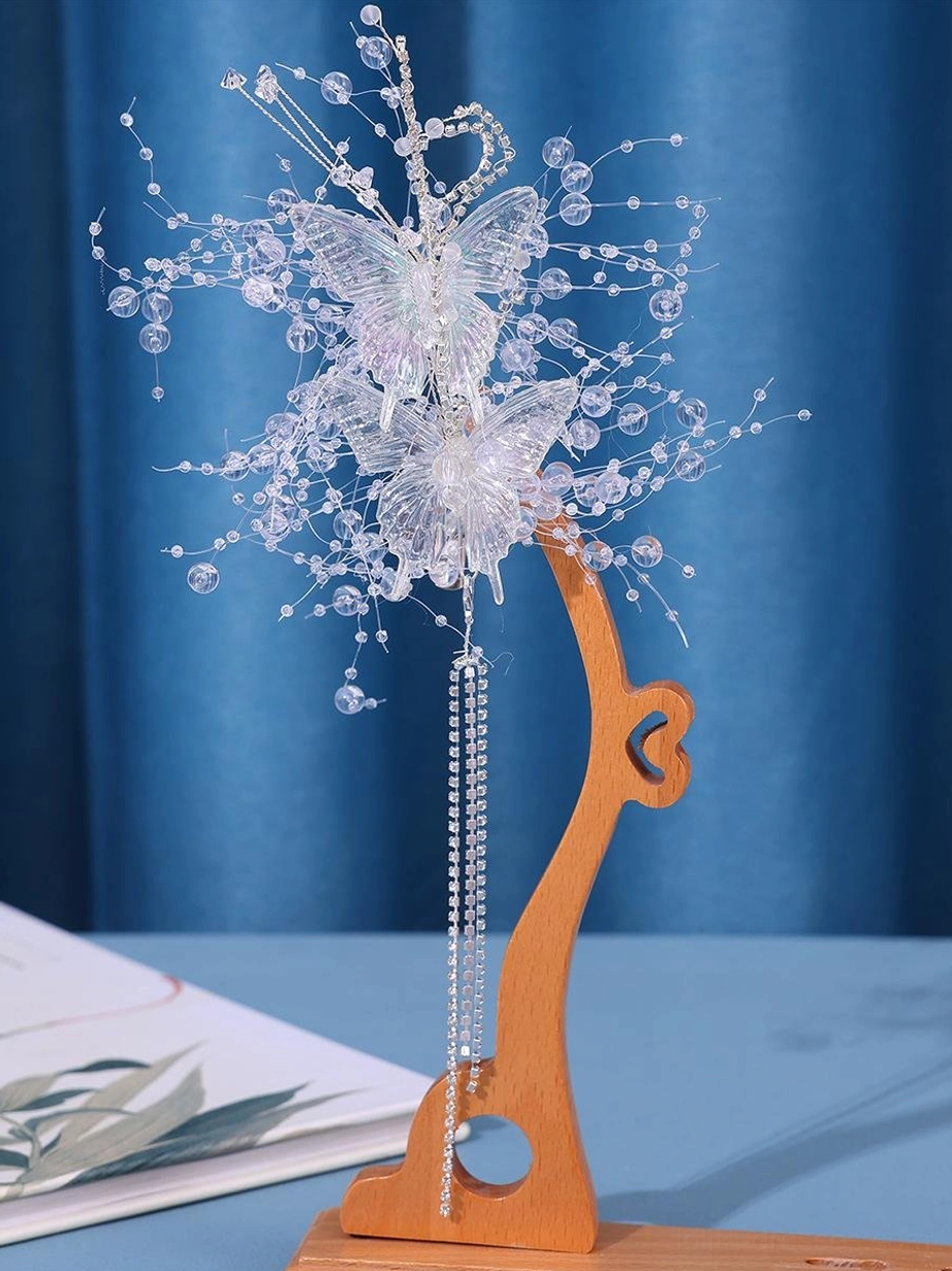 Single butterfly hair accessory close-up display showing dual butterfly layers crystal wire accents and long rhinestone cascading tassel detail