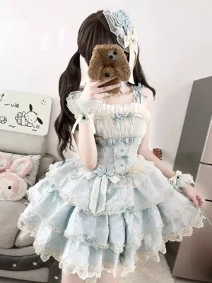 Sky blue sweet lolita dress sleeveless front view with tiered ruffles and off-white trim, modeled indoors with Pochacco decorations and flower hair bow accessory