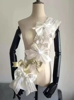 Sky blue Lolita bow shoulder accessory with white accents and printed ribbon details displayed on dress form front view