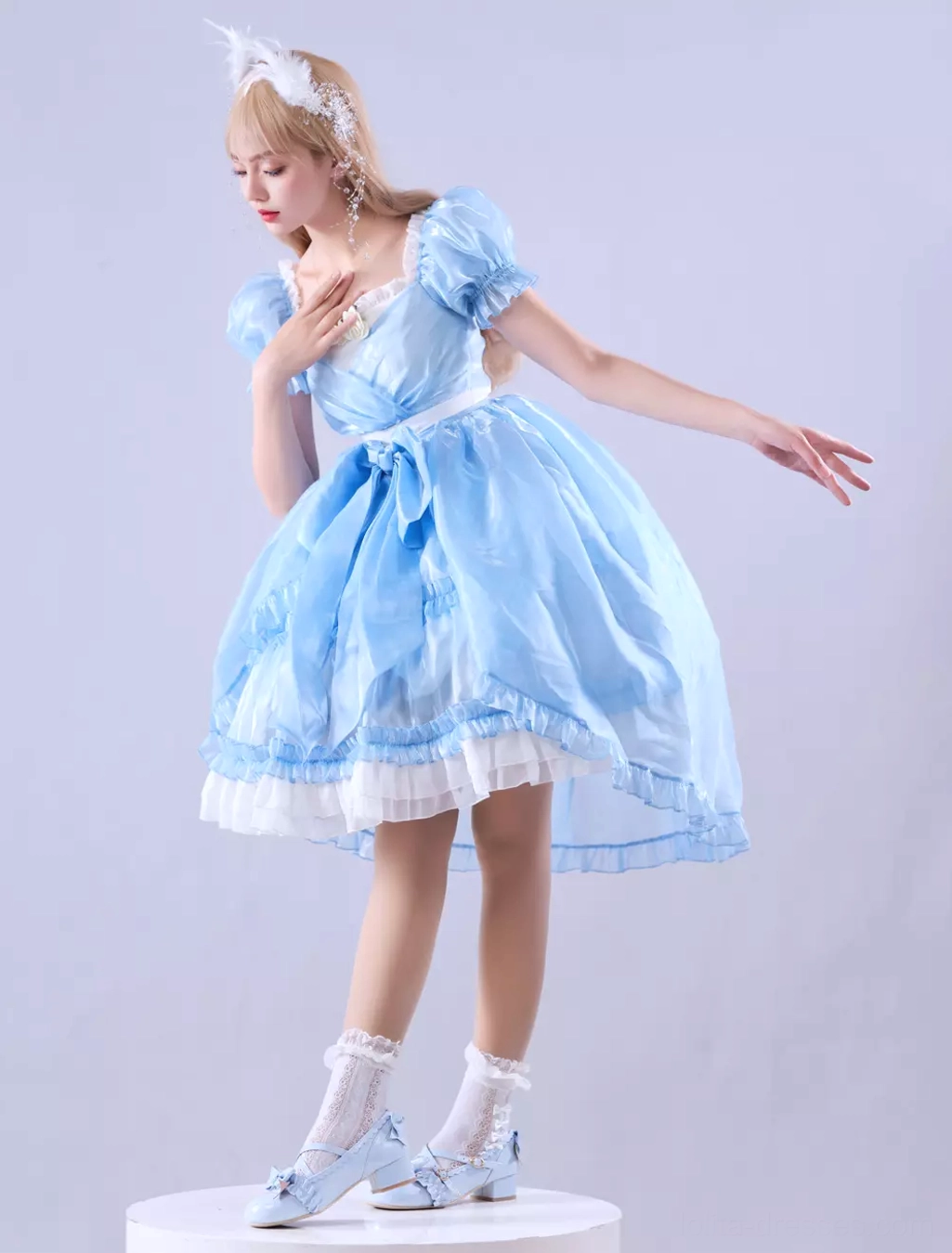 Close-up detail view of sky blue lolita dress construction showing satin ribbon embellishments, high-quality fabric blend, and ruffled hem construction