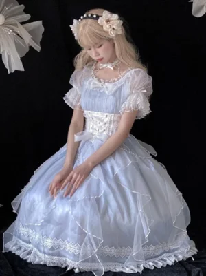Sky blue Lolita fairy dress front seated view showcasing square neckline, pearl chain decoration, layered tulle skirt volumes, and romantic silhouette with flower hairband accessory