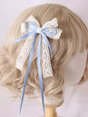 sky blue satin ribbon lace bow lolita hair clip headdress with flowing ribbon tails displayed on mannequin with blonde wig showing rear view crochet lace texture white and blue romantic