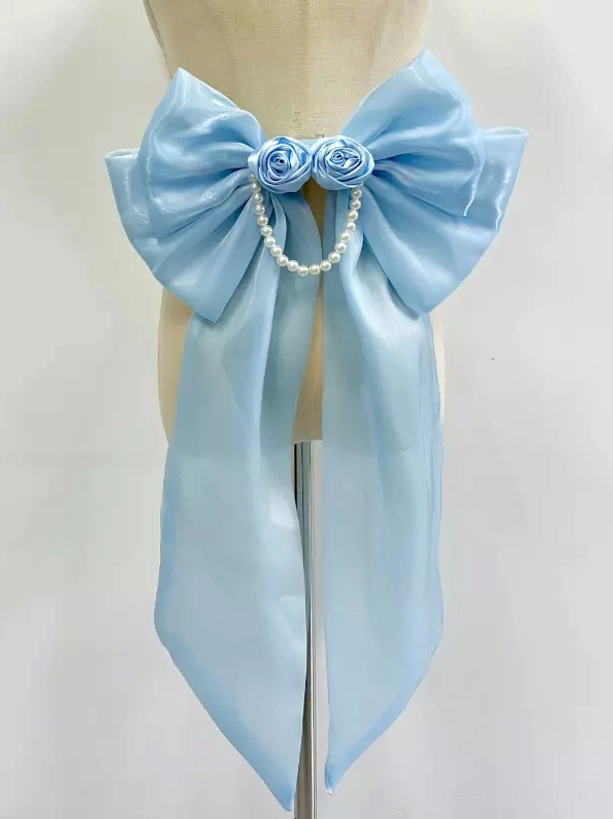 Sky blue satin Lolita bow train with rose and pearl chain accents front display on headless mannequin