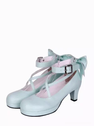 Sky blue sweet lolita heels three-quarter front view showing cross ankle straps with square buckle fasteners and decorative rear bow embellishment against white background