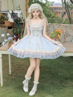Sky blue sweet lolita jsk dress full body front view with matching lace-up corset bodice, white lace trim, tiered ruffled skirt, coordinating lace hairpiece and choker - garden setting with floral backdrop