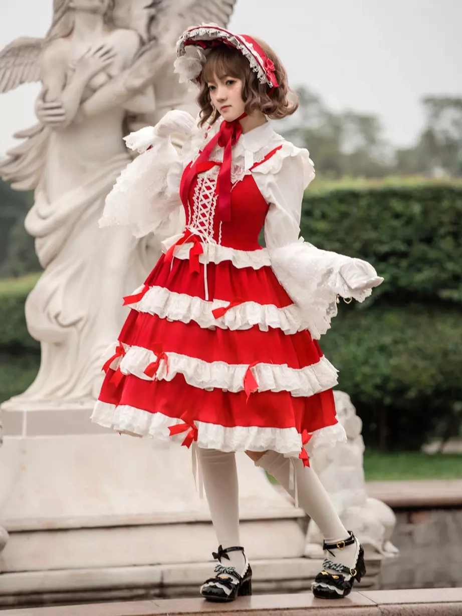 Sleeveless lolita dress front view lace-up bodice white under-blouse ruffled cuffs garden outdoor setting