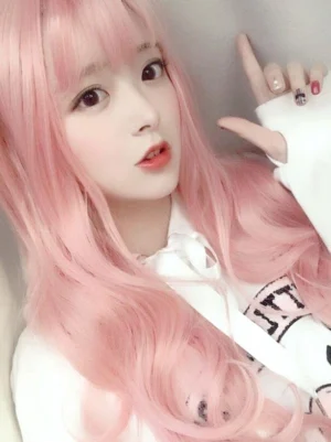 soft pink long wavy lolita wig with full bangs front view close-up portrait sweet lolita style synthetic hair
