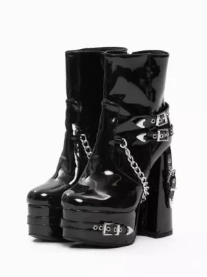 Black patent leather steampunk lolita platform boots front view with silver chains and metal grommets against white background