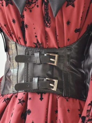 Black PU leather steampunk lolita corset belt with dual silver metal buckles worn on red star-print lolita dress front waist close-up view