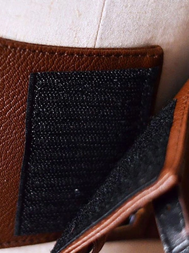 Velcro fastener and hook-and-loop closure detail of steampunk lolita corset with brown leather edging and matte black velcro surface