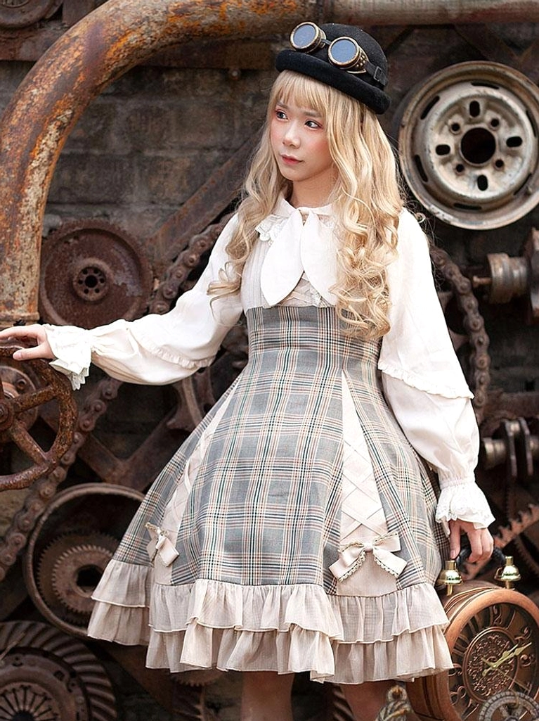 Steampunk Lolita dress set with camel coloring, goggle-decorated hat, lace-up bodice details, front full-body industrial background setting