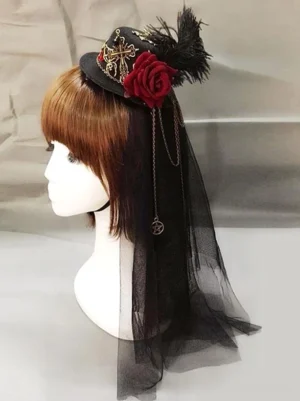 Steampunk Lolita Mini Top Hat Headdress featuring wine red fabric rose, black feathers, vintage metal charms, and pleated black tulle veil with hanging chains, displayed on mannequin with brown straight bangs wig, left side profile view