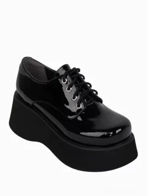 Single black patent leather lolita platform shoe side view, showing thick platform sole, metal lace hardware, industrial steampunk aesthetic, and glossy patent leather finish