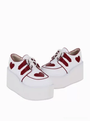 Top-front view of white lolita platform shoes with red heart accents and thick wedge platform heel thick sole construction