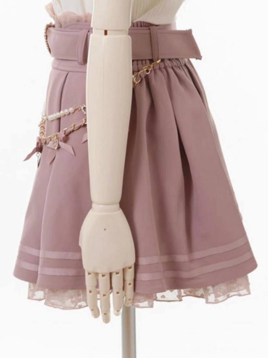 Pink steampunk lolita skirt side view showing wide waist belt, chain and bow decorations, striped lace hem trim, detailed grommet hardware placement