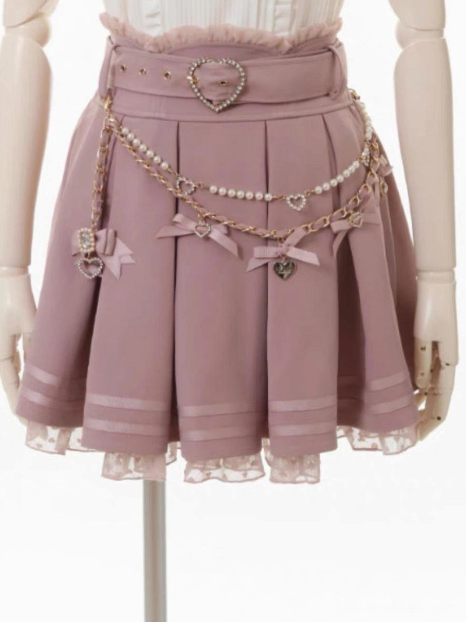 Pink pleated lolita skirt with white grommets, heart-shaped belt buckle, decorative chains and bows, multi-layer ruffled lace hem, front mannequin close-up