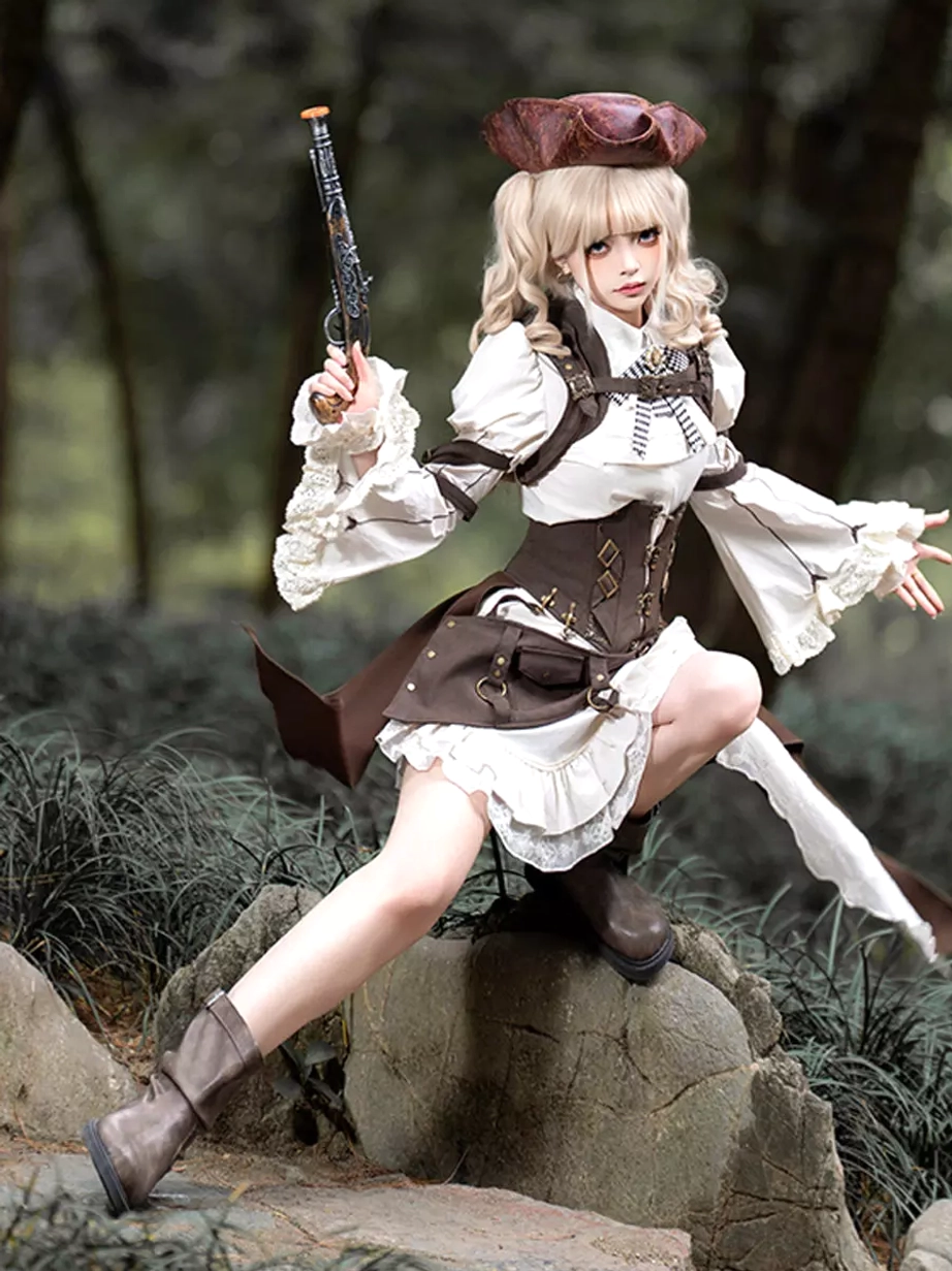Steampunk lolita outfit three-quarter crouching pose showcasing asymmetrical skirt design with layered ruffles, brown ankle boots, and full ensemble details on forest rock