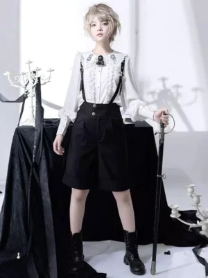 Steampunk Ouji Lolita black bloomers front full-body view on short blonde model wearing white ruffled blouse with brooch gothic studio setting
