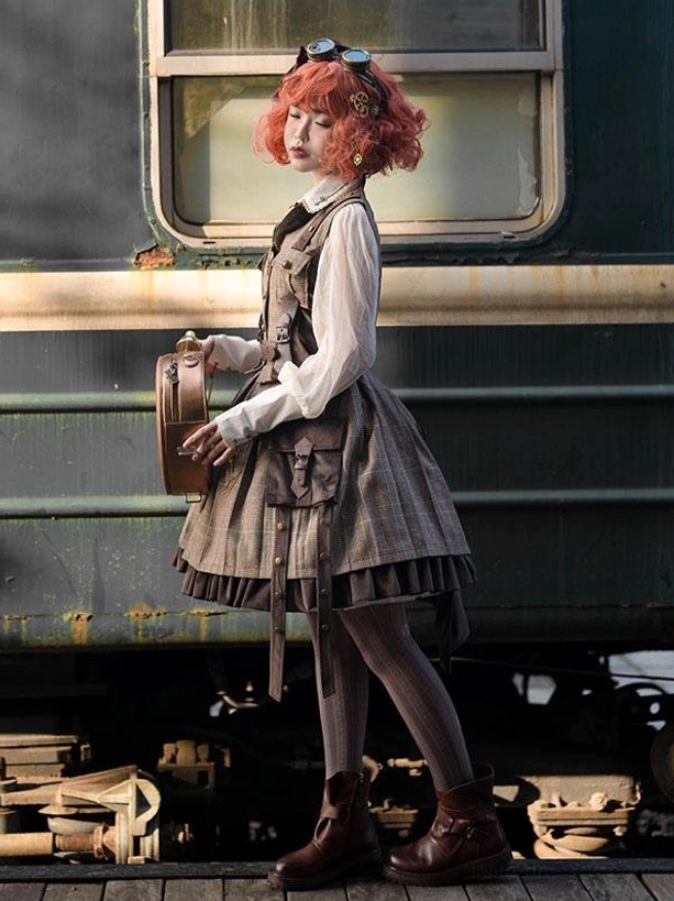 Steampunk Ouji Lolita outfit side full-body view with red-haired model wearing brown cardigan coordinate with vintage leather handbag on train platform scene