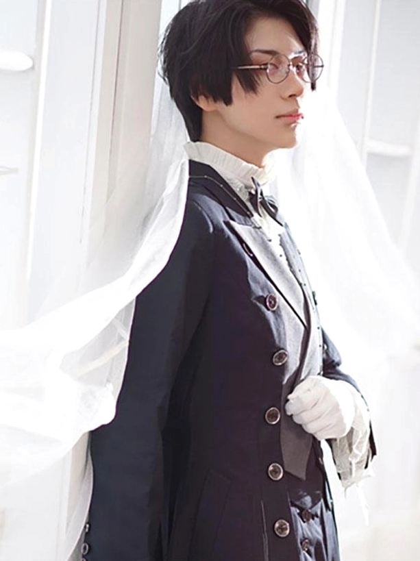 Real person wearing dark navy steampunk Ouji Lolita coat side profile view with white veil gloves formal elegant alternative fashion styling