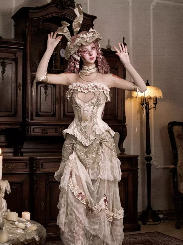 Strapless ivory lolita gown with tiered lace skirt and floral trim details, full front view demonstrating architectural bustle silhouette