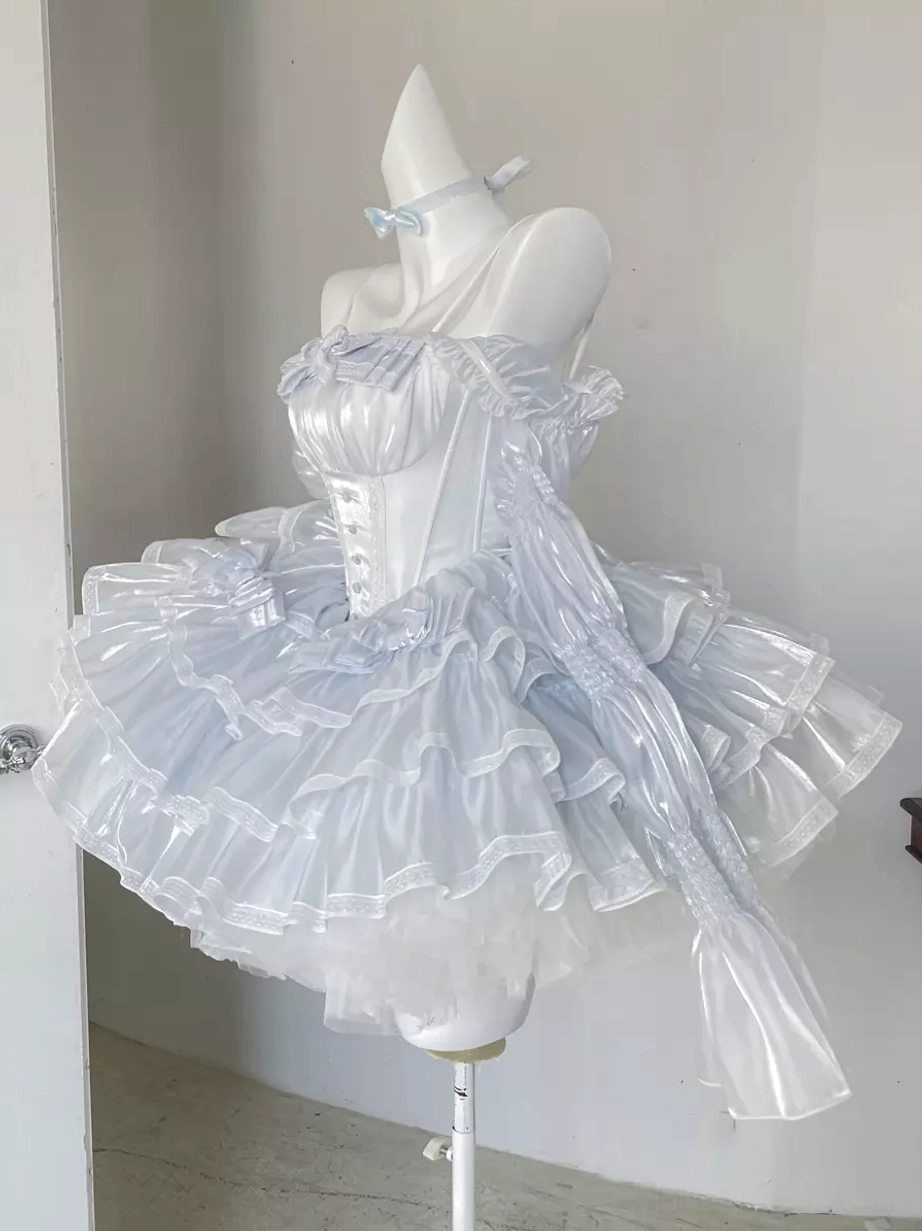 Strapless fairy lolita dress front three-quarter view featuring light blue bow choker, fitted corset top, layered sheer ruffled skirt, and long detachable left sash