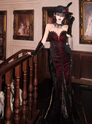 Strapless mermaid Gothic Lolita dress wine red black lace sweetheart neckline three-quarter front view with wide-brimmed gothic hat and black lace gloves vintage indoor staircase setting
