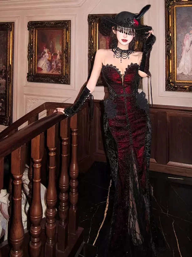 Strapless mermaid Gothic Lolita dress wine red black lace sweetheart neckline three-quarter front view with wide-brimmed gothic hat and black lace gloves vintage indoor staircase setting