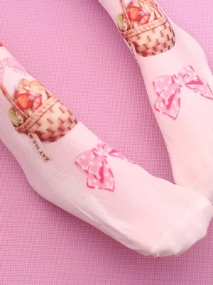 Close-up side view of strawberry basket pink velvet Lolita socks with polka dot bows and detailed strawberry basket print design on pink fabric