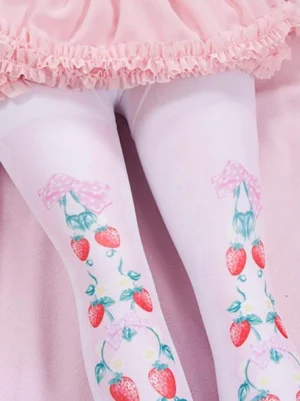 Close-up overhead view of strawberry fruit print lolita pantyhose thigh area displaying detailed strawberry vine and pink bow patterns