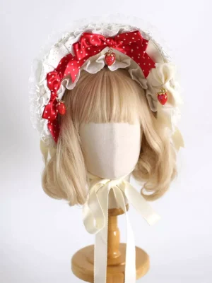 Strawberry sweet lolita bonnet front view with red polka dot bows strawberry pendants and white ruffled lace trim with cream satin chin strap