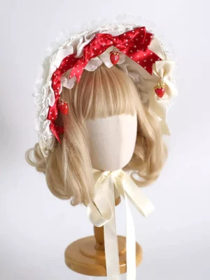 Lolita strawberry bonnet three quarter front angle showing red polka dot bows strawberry charms layered ruffled edges and cream tying ribbons