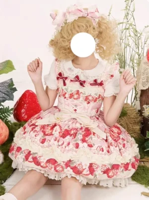 Strawberry sweetheart sweet lolita dress frontal view with pink print tiered ruffled skirt red bows blonde wig indoor plant props