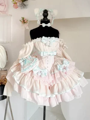 Sweet ballet lolita dress with detachable puff sleeves in soft pink and mint blue, featuring tiered ruffled skirt and decorative bows, front full-body view on model in studio setting with floral ornaments