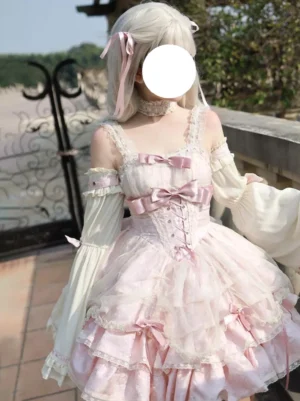 Sweet ballet lolita jumper dress with layered tulle ruffle skirt and lace-up corset detailing showcasing front view on stone balcony setting