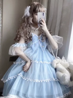 Baby blue off-shoulder sweet Lolita JSK dress with sheer puff sleeves, pom pom trims and large front bow, mirror selfie view