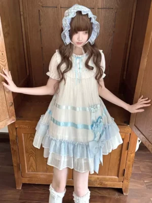 Full body shot of blue white striped sweet lolita babydoll dress with tiered ruffle hem and coordinating ribbon bows worn indoors